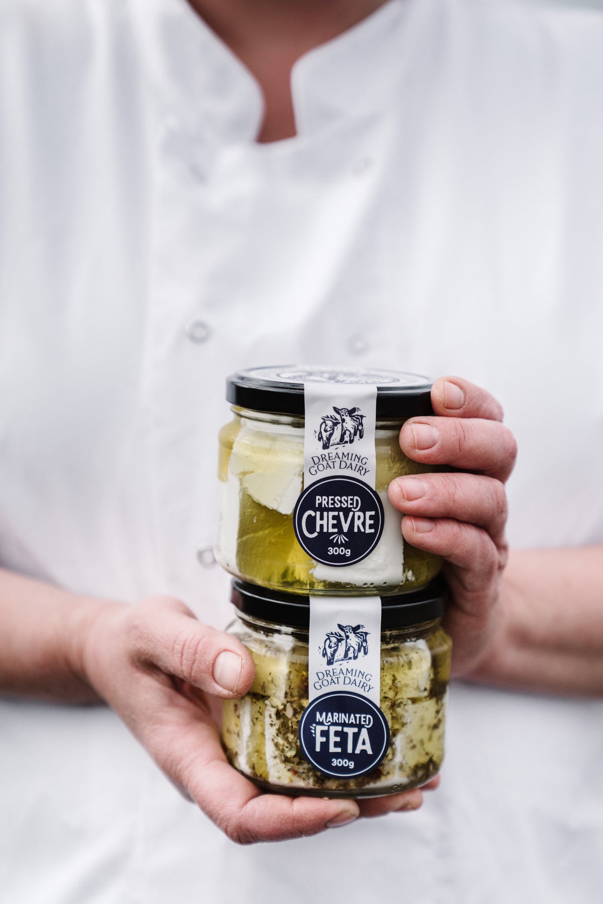A chef holding Dreaming Goat Dairy Chevre and Feta from the Macedon Ranges