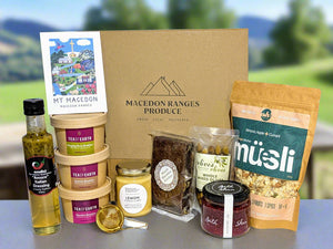 Collection of food products including a bottle, jars, and a package with 'Macedon Ranges Produce' branding.