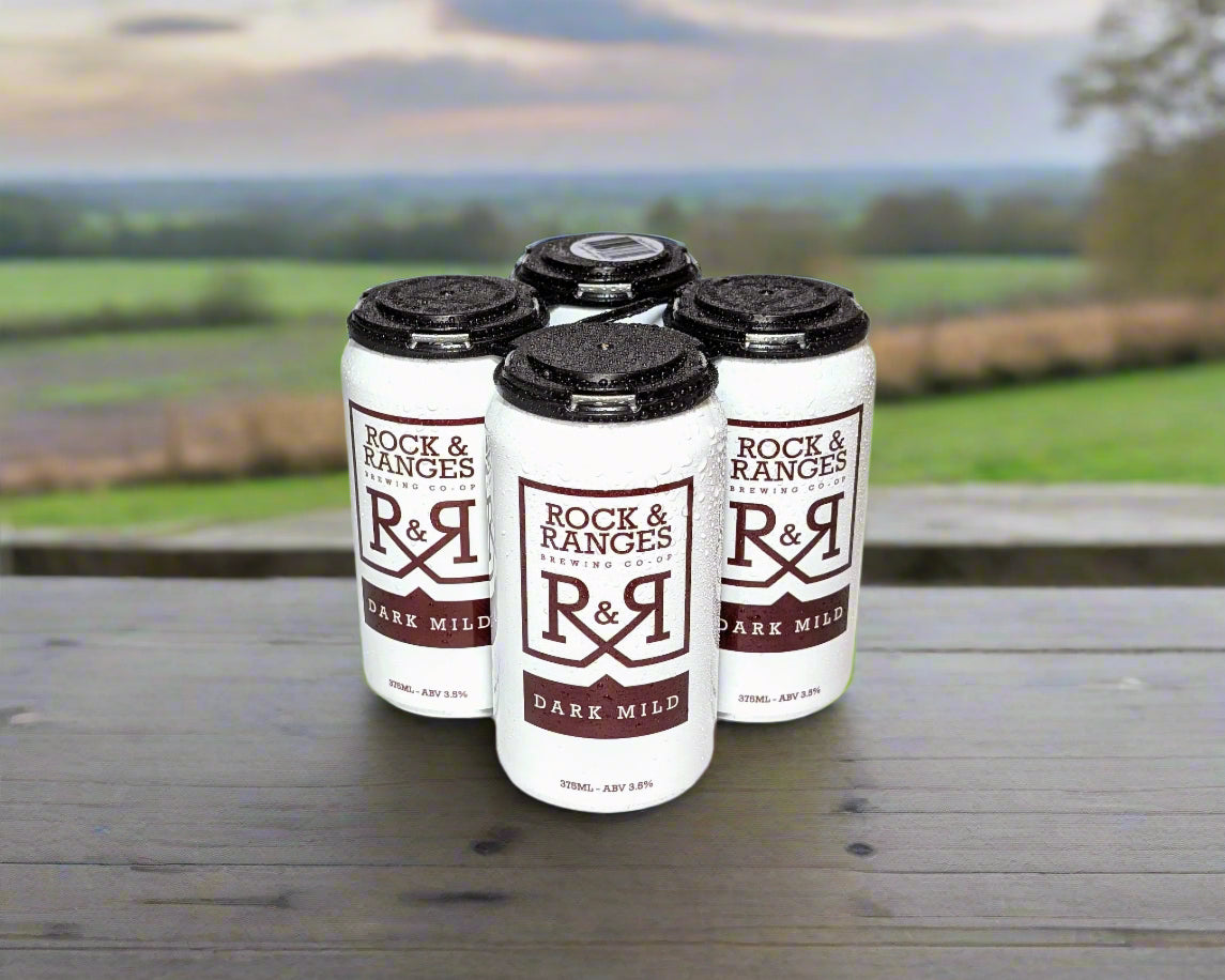 4 cans of Macedon Ranges dark mild beer in rural setting