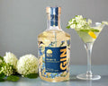 a bottle of elderflower gin distilled in the Macedon Ranges with martini glass and fresh elderflowers