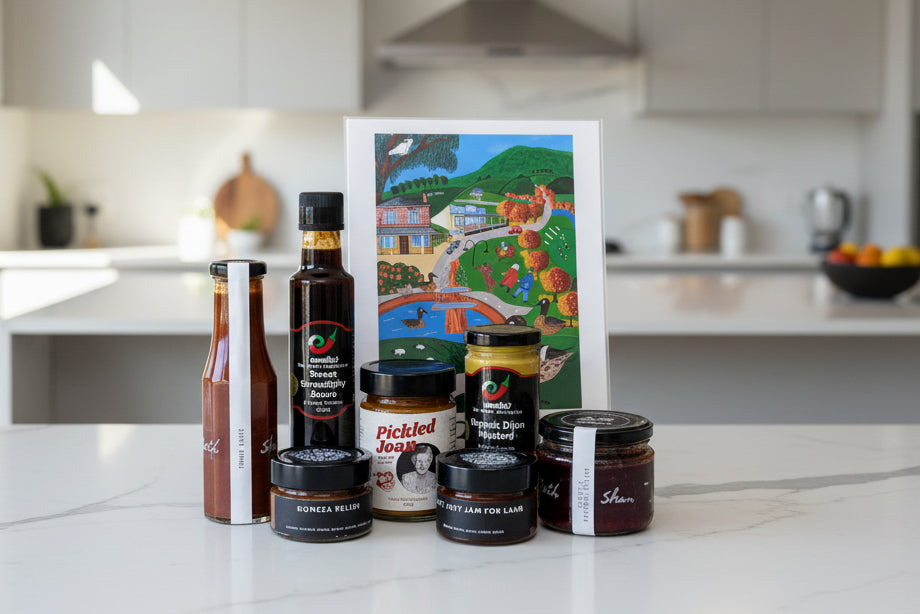 a collection of gourmet condiments and a4 local town artwork from the macedon ranges