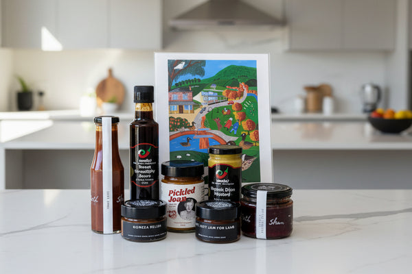 a collection of gourmet condiments and a4 local town artwork from the macedon ranges