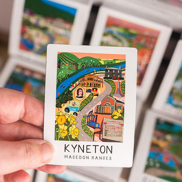 Hand holding a magnet with an illustration of Kyneton, Macedon Ranges
