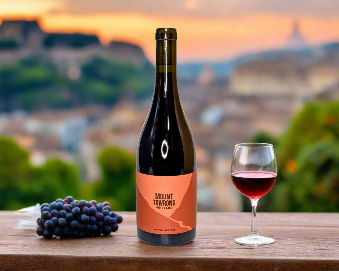 A bottle of Negroamaro from the Macedon Ranges in outdoor dining setting at sunset