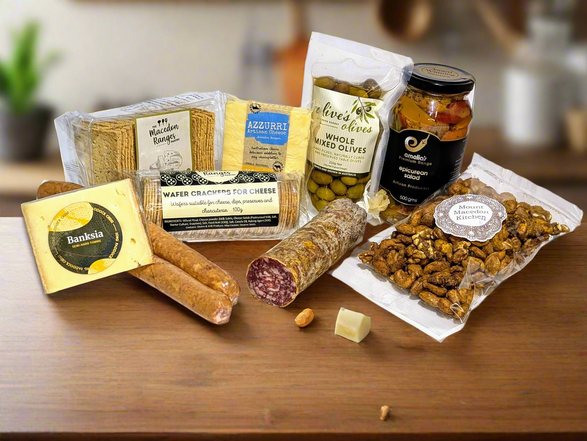 a box of snacks from the macedon ranges including nuts, cheeses, salami, pickled onions. 