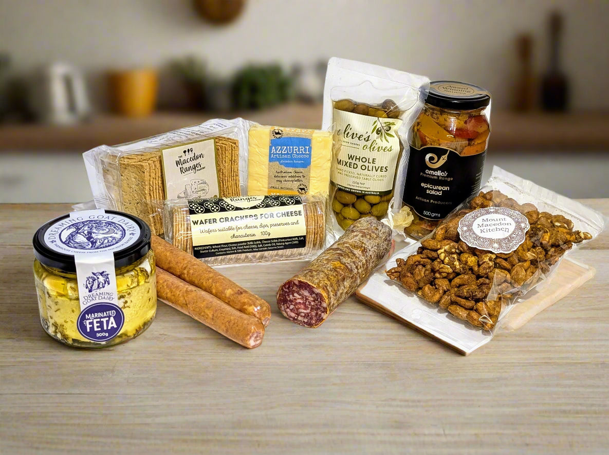 a selection of meats, cheeses, nuts, olives, pickles and crackers from the macedon ranges  