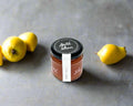 a jar of quince past from the Macedon Ranges on kitchen bench with quinces 