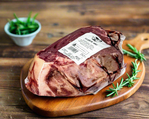 roast beef grown in the Macedon Ranges on cutting board with rosemary getting ready to roast