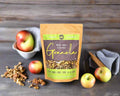 a bag of walnut, apple and cinnamon granola made in the Macedon Ranges on a breakfast bench with apples, walnut and cinnamon