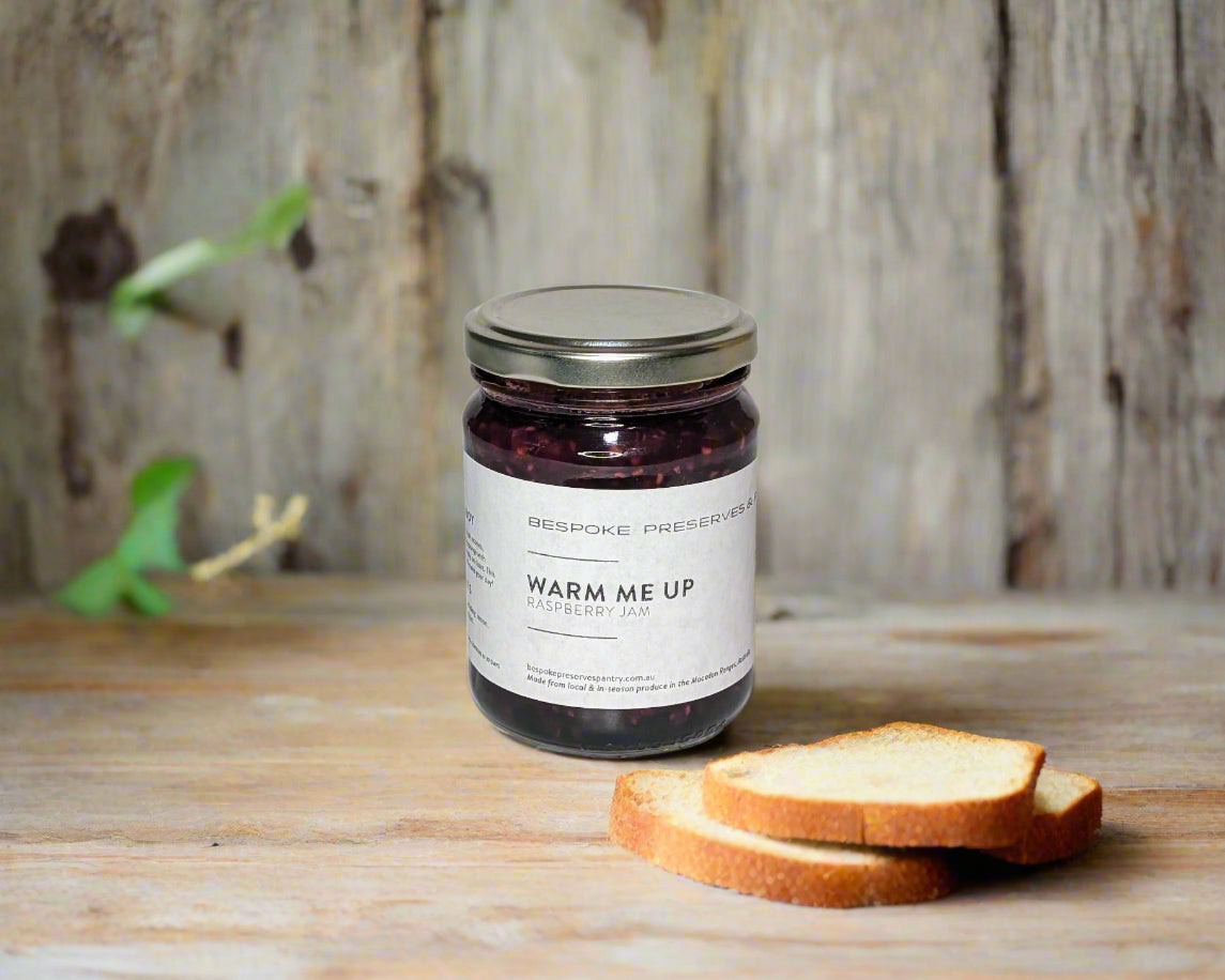 a jar of raspberry jam from the Macedon Ranges on kitchen table with some toast
