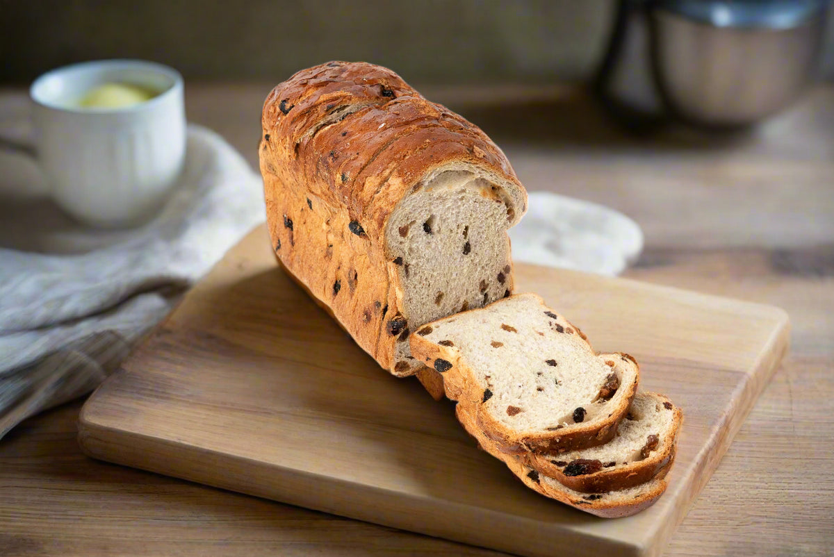 a cut fresh loaf of fruit loaf or fruit toast on a bread board in the Macedon Ranges
