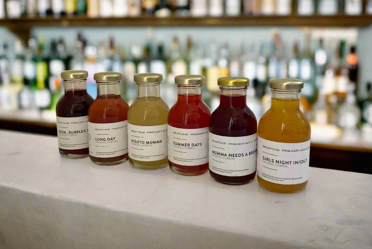 six bottles of different cordials made with fresh ingredients from the Macedon Ranges on a cocktail bar